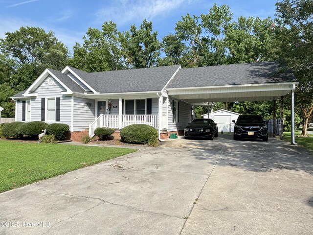 103 Jay Trl, Murfreesboro, NC 27855 - view of front facade with covered porch, a front yard, driveway, roof with shingles, and an attached carport