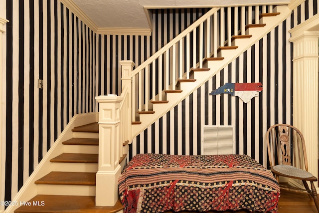 119 S Main St, Colerain, NC 27924 - stairway with wallpapered walls, ornamental molding, and wood finished floors