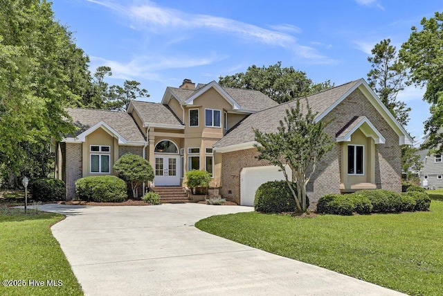 108 Sound View Dr, Hampstead, NC 28443 - traditional home featuring driveway, brick siding, french doors, and an attached garage