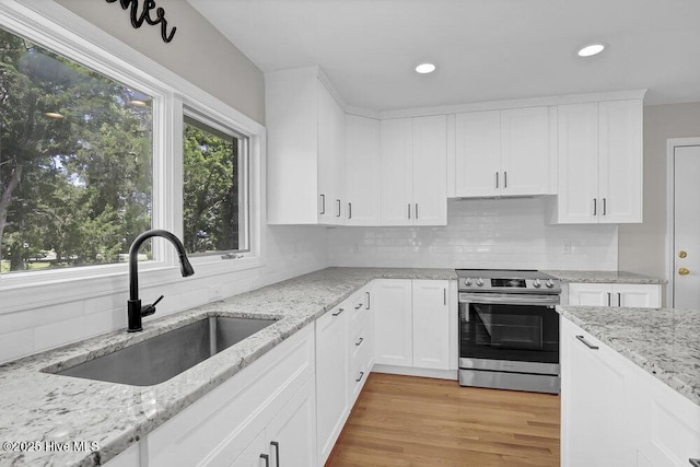 108 Sound View Dr, Hampstead, NC 28443 - kitchen featuring electric stove, backsplash, white cabinets, recessed lighting, and light wood-style floors