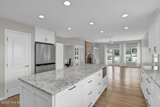 108 Sound View Dr, Hampstead, NC 28443 - kitchen featuring stainless steel appliances, ceiling fan, recessed lighting, light wood finished floors, and a center island