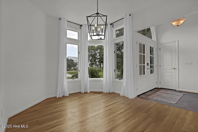 108 Sound View Dr, Hampstead, NC 28443 - foyer entrance with healthy amount of natural light, a chandelier, and wood finished floors