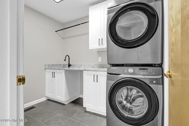 108 Sound View Dr, Hampstead, NC 28443 - washroom with stacked washer / dryer, cabinet space, and tile patterned floors