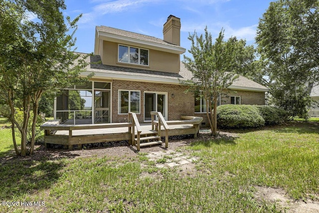 108 Sound View Dr, Hampstead, NC 28443 - back of property featuring a deck, a chimney, a shingled roof, brick siding, and a sunroom