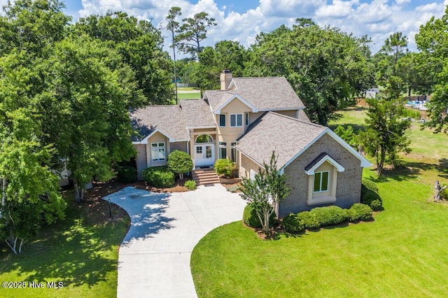 108 Sound View Dr, Hampstead, NC 28443 - traditional-style home featuring a chimney, a front yard, brick siding, and a shingled roof