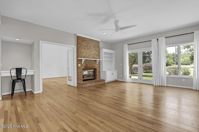 108 Sound View Dr, Hampstead, NC 28443 - unfurnished living room with a ceiling fan, light wood-type flooring, and a brick fireplace