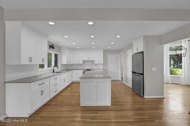 108 Sound View Dr, Hampstead, NC 28443 - kitchen featuring freestanding refrigerator, decorative backsplash, white cabinets, wood finished floors, and recessed lighting