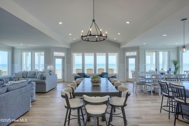 1326 New River Inlet Rd, North Topsail Beach, NC 28460 - dining room featuring plenty of natural light, a chandelier, lofted ceiling, recessed lighting, and light wood finished floors