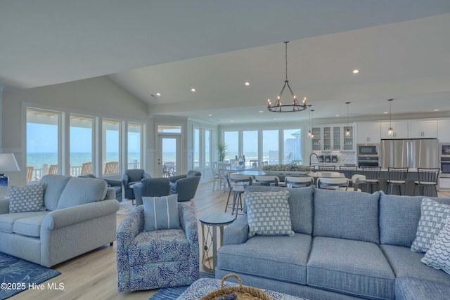 1326 New River Inlet Rd, North Topsail Beach, NC 28460 - living room featuring a chandelier, light wood-type flooring, recessed lighting, healthy amount of natural light, and vaulted ceiling