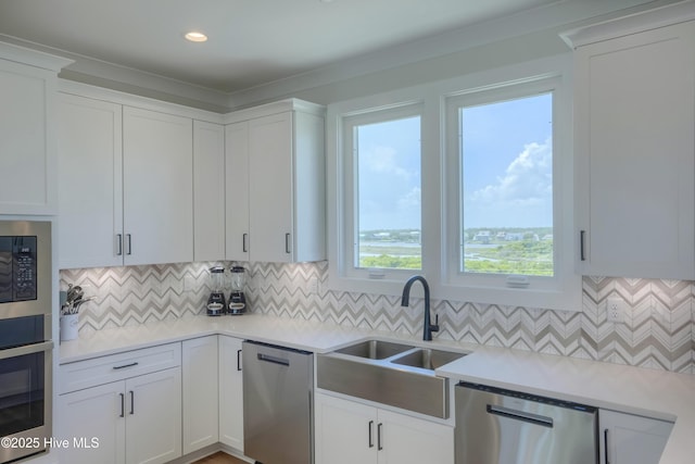 1326 New River Inlet Rd, North Topsail Beach, NC 28460 - kitchen featuring appliances with stainless steel finishes, white cabinetry, tasteful backsplash, and light countertops