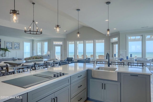 1326 New River Inlet Rd, North Topsail Beach, NC 28460 - kitchen featuring open floor plan, light countertops, gray cabinetry, lofted ceiling, and black electric stovetop