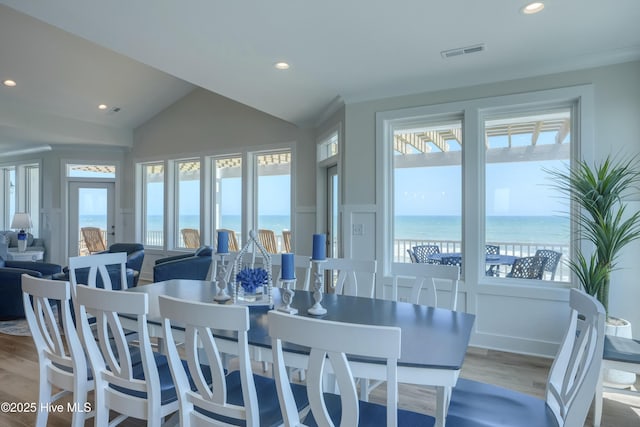 1326 New River Inlet Rd, North Topsail Beach, NC 28460 - dining room featuring wood finished floors, vaulted ceiling, plenty of natural light, recessed lighting, and a water view