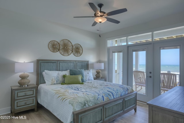 1326 New River Inlet Rd, North Topsail Beach, NC 28460 - bedroom featuring access to outside, light wood finished floors, a ceiling fan, and a water view