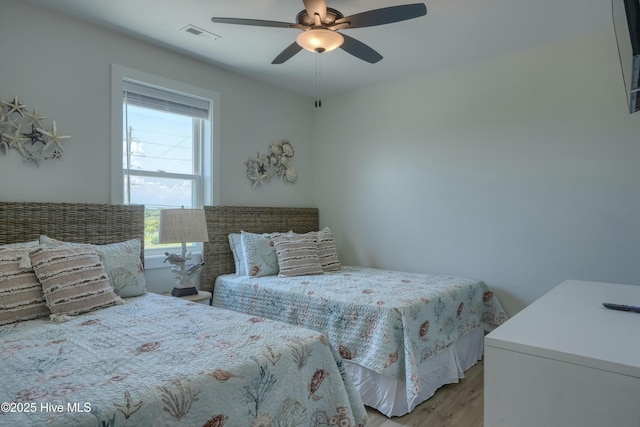 1326 New River Inlet Rd, North Topsail Beach, NC 28460 - bedroom featuring light wood-style flooring and a ceiling fan
