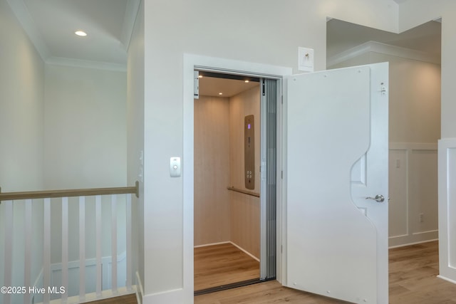 1326 New River Inlet Rd, North Topsail Beach, NC 28460 - corridor with wood finished floors, ornamental molding, and elevator