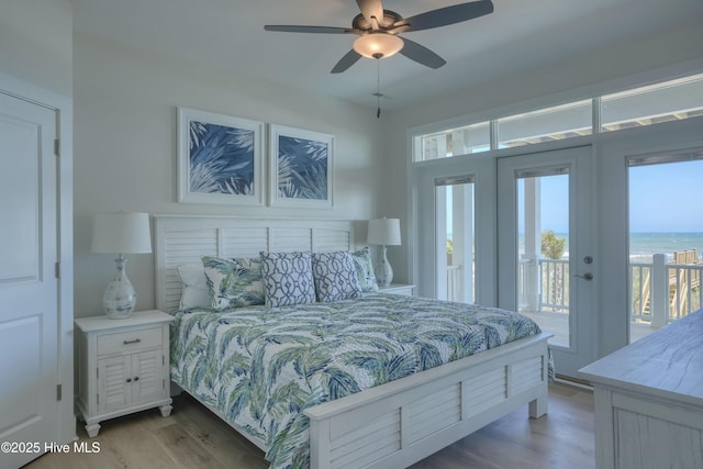 1326 New River Inlet Rd, North Topsail Beach, NC 28460 - bedroom with access to exterior, light wood-type flooring, and multiple windows