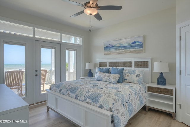 1326 New River Inlet Rd, North Topsail Beach, NC 28460 - bedroom with access to outside, light wood-type flooring, a water view, and ceiling fan