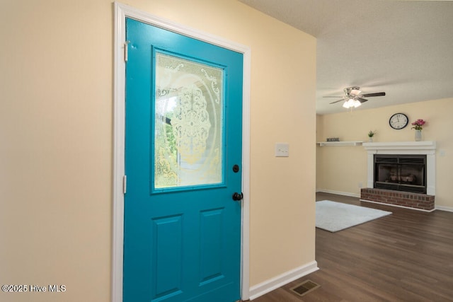 5025 NC Highway 55 E, New Bern, NC 28560 - foyer with dark wood-style floors, a ceiling fan, and a brick fireplace