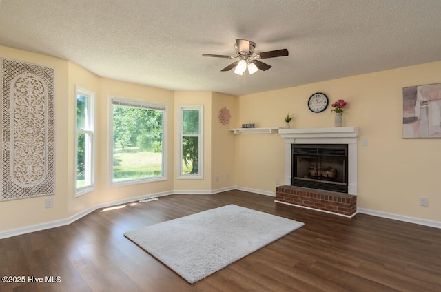 5025 NC Highway 55 E, New Bern, NC 28560 - unfurnished living room featuring dark wood finished floors, a textured ceiling, a brick fireplace, and a ceiling fan