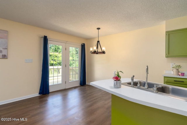 5025 NC Highway 55 E, New Bern, NC 28560 - kitchen with green cabinets, a chandelier, dark wood-style flooring, a textured ceiling, and light countertops