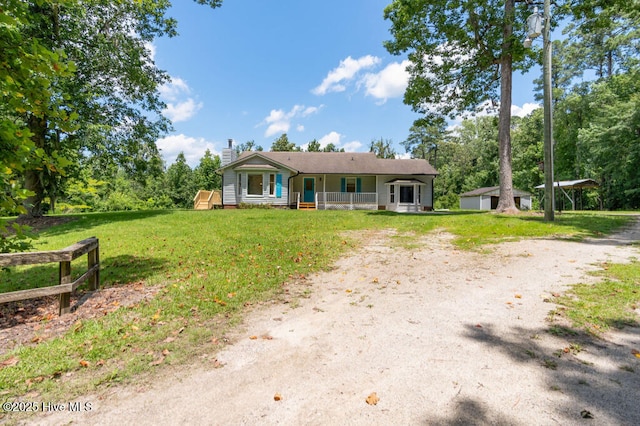 5025 NC Highway 55 E, New Bern, NC 28560 - ranch-style home featuring covered porch, a chimney, a front yard, and dirt driveway