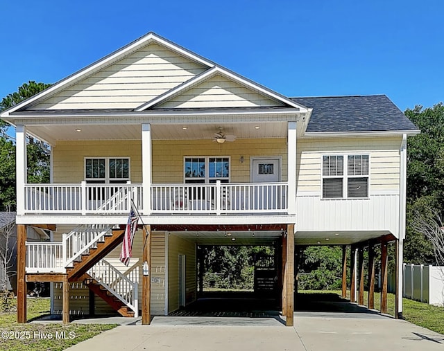 109 SW 17th St, Oak Island, NC 28465 - coastal inspired home with a carport, stairs, concrete driveway, roof with shingles, and a porch