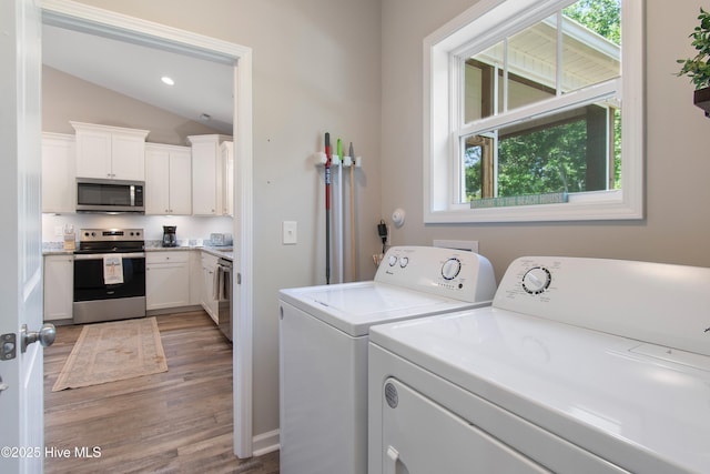 109 SW 17th St, Oak Island, NC 28465 - laundry room featuring washer and clothes dryer, healthy amount of natural light, light wood-style floors, and recessed lighting