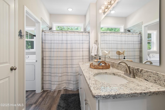 109 SW 17th St, Oak Island, NC 28465 - full bath featuring washer / dryer, vanity, wood finished floors, and healthy amount of natural light