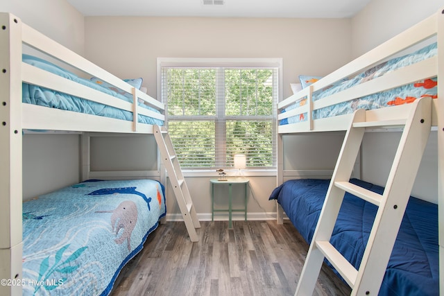 109 SW 17th St, Oak Island, NC 28465 - bedroom with wood finished floors and multiple windows