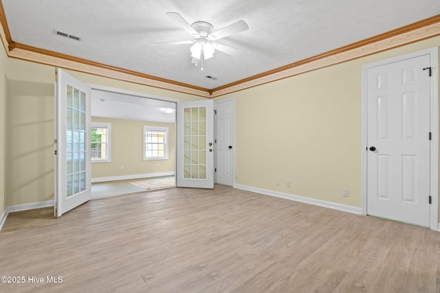 383 Red Fox St NW, Shallotte, NC 28470 - unfurnished room with ornamental molding, light wood-type flooring, french doors, ceiling fan, and a textured ceiling