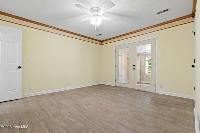 383 Red Fox St NW, Shallotte, NC 28470 - empty room with french doors, crown molding, light wood finished floors, ceiling fan, and a textured ceiling