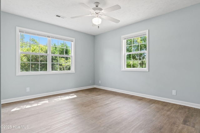 383 Red Fox St NW, Shallotte, NC 28470 - unfurnished room with healthy amount of natural light, wood finished floors, and ceiling fan