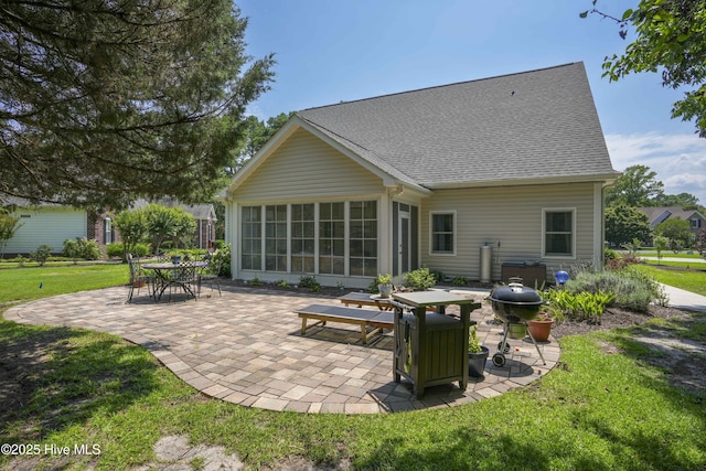 107 Sea Turtle Cv, Sneads Ferry, NC 28460 - rear view of property featuring a patio area, a yard, a shingled roof, and a sunroom