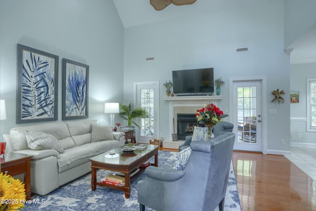 107 Sea Turtle Cv, Sneads Ferry, NC 28460 - living area featuring high vaulted ceiling, a fireplace with raised hearth, ceiling fan, and wood finished floors