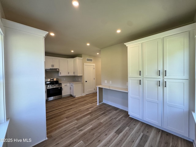 317 Whitfield Dr, Goldsboro, NC 27530 - kitchen featuring stainless steel range, white cabinets, wood finished floors, recessed lighting, and light countertops
