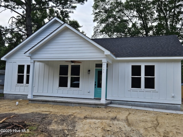 7151 Dale Ave SW, Ocean Isle Beach, NC 28469 - view of front facade featuring covered porch, board and batten siding, ceiling fan, and a shingled roof