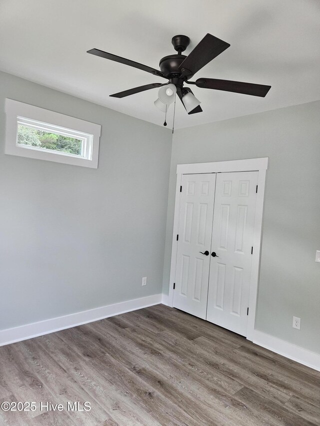 7151 Dale Ave SW, Ocean Isle Beach, NC 28469 - unfurnished bedroom with wood finished floors, a closet, and ceiling fan