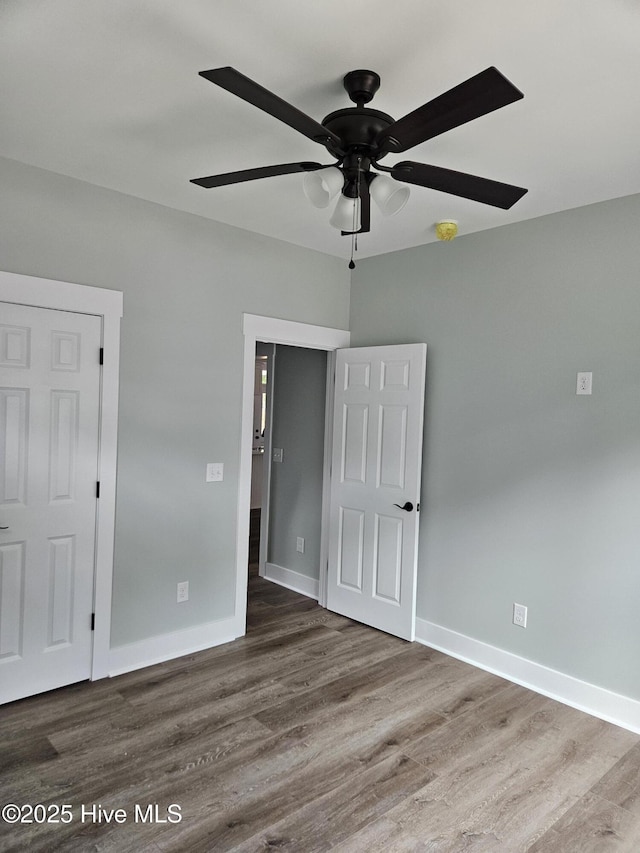 7151 Dale Ave SW, Ocean Isle Beach, NC 28469 - unfurnished bedroom with wood finished floors and ceiling fan