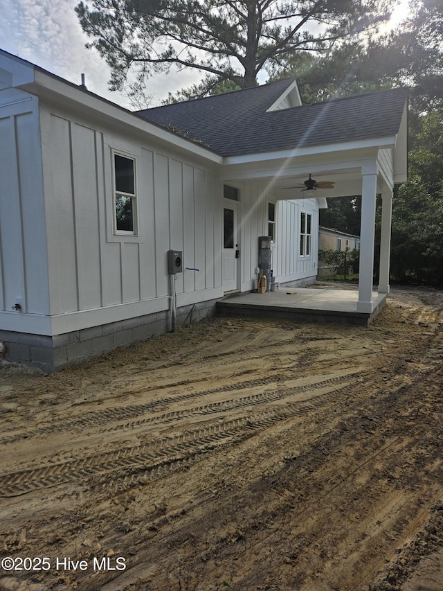 7151 Dale Ave SW, Ocean Isle Beach, NC 28469 - back of house with board and batten siding, ceiling fan, and a shingled roof