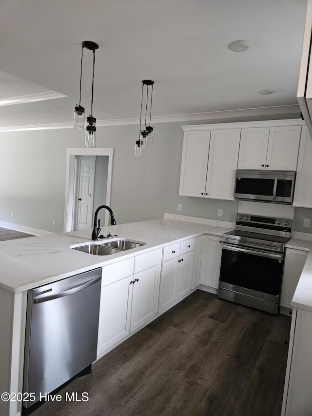 7151 Dale Ave SW, Ocean Isle Beach, NC 28469 - kitchen with appliances with stainless steel finishes, a peninsula, crown molding, dark wood-type flooring, and white cabinetry