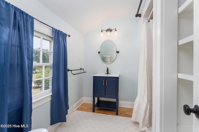 429 Tanbridge Rd, Wilmington, NC 28405 - full bath with vaulted ceiling, vanity, wood finished floors, and a shower with shower curtain