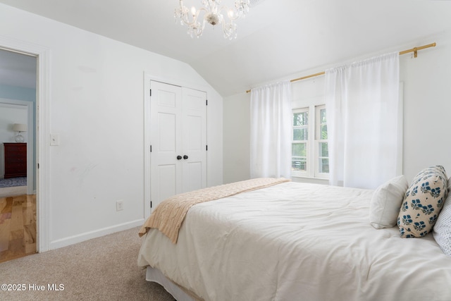 429 Tanbridge Rd, Wilmington, NC 28405 - carpeted bedroom with a chandelier, vaulted ceiling, and a closet