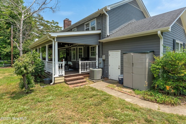 429 Tanbridge Rd, Wilmington, NC 28405 - back of property with a yard, a chimney, a shingled roof, and a porch