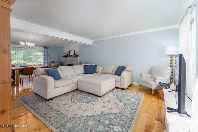 429 Tanbridge Rd, Wilmington, NC 28405 - living area featuring a chandelier, light wood-style flooring, crown molding, and a fireplace