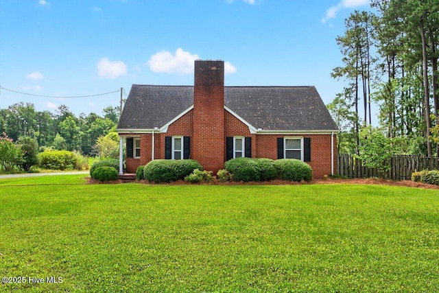 view of front of property with a chimney, brick siding, and roof with shingles