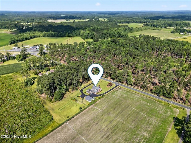 view of property location with a forest