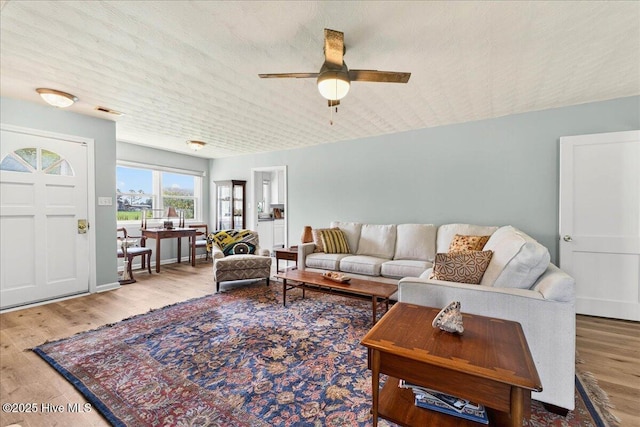 living room featuring wood finished floors and a ceiling fan