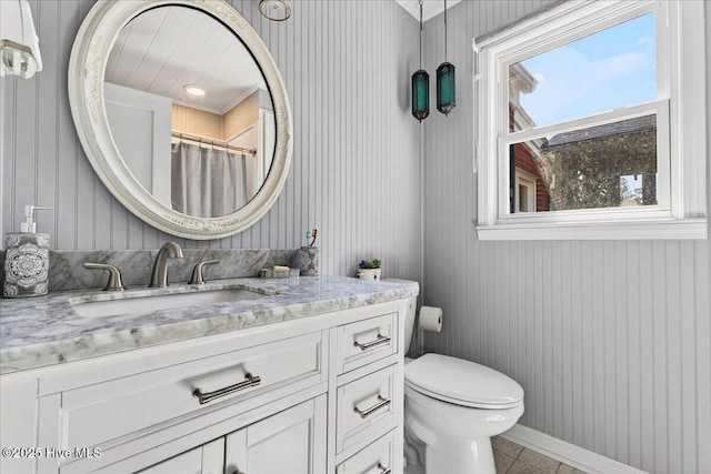 bathroom with vanity, tile patterned floors, and wooden walls