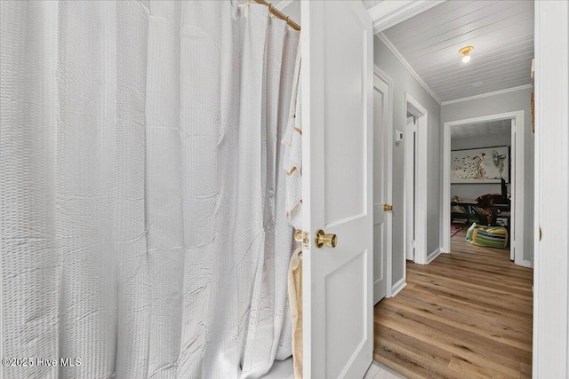 hallway featuring crown molding and wood finished floors