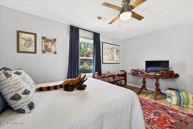 bedroom featuring wood finished floors and baseboards